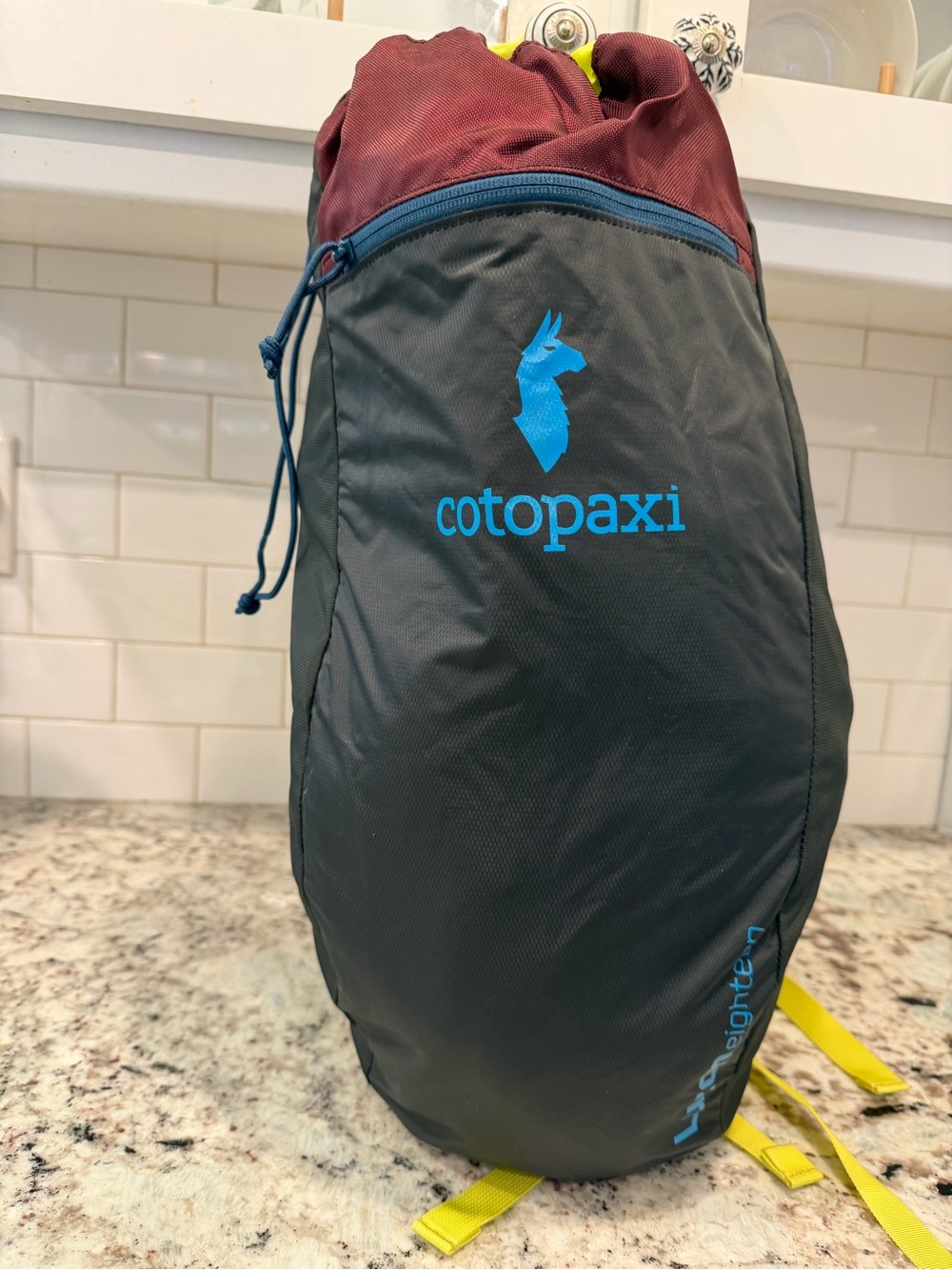 cotopaxi Gray & Burgundy Backpack with Blue Logo and Yellow Straps